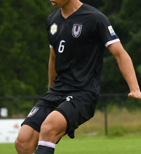 A player wearing a black shirt with mauve highlights.
